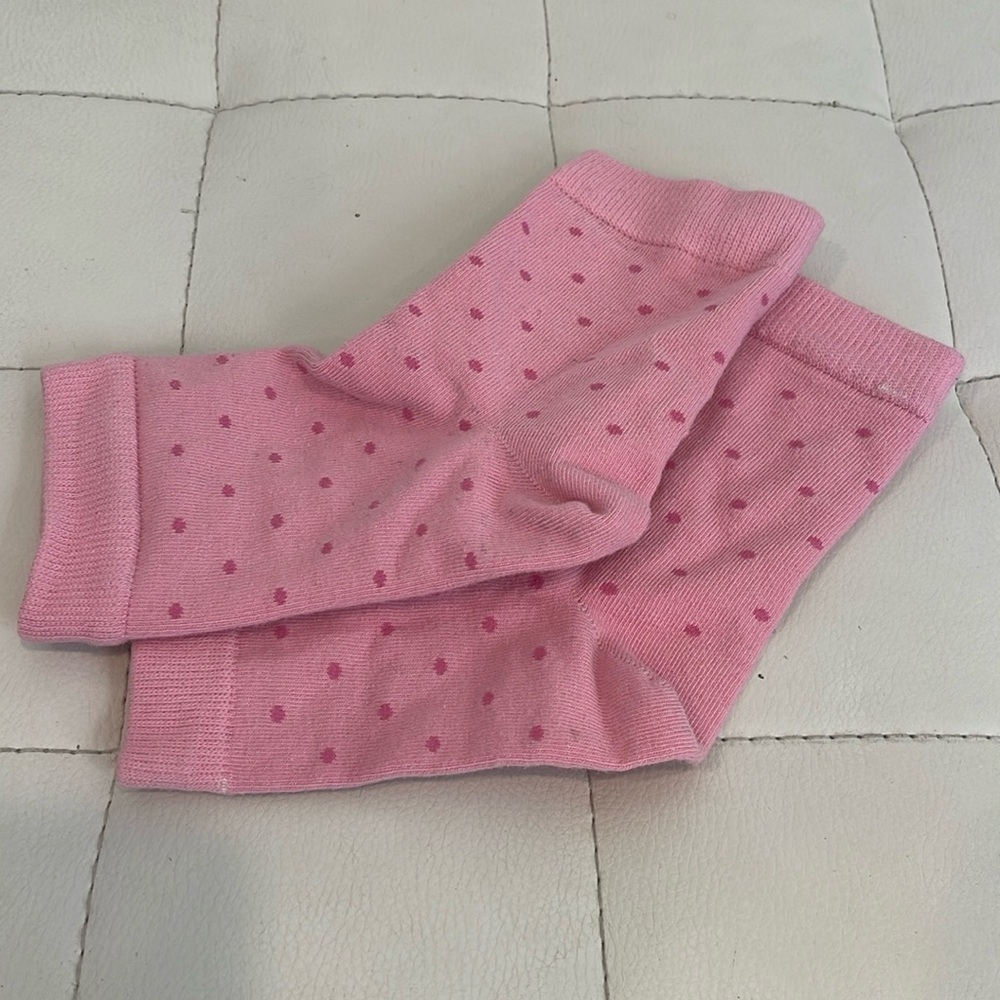 Pair of footless polka dot pink socks